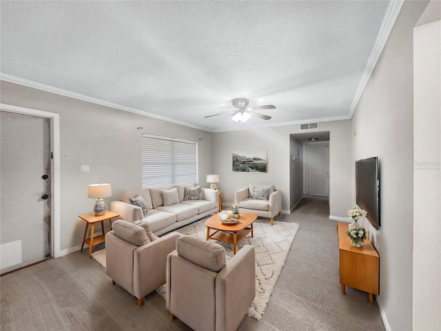 living room featuring ceiling fan, ornamental molding, and a textured ceiling