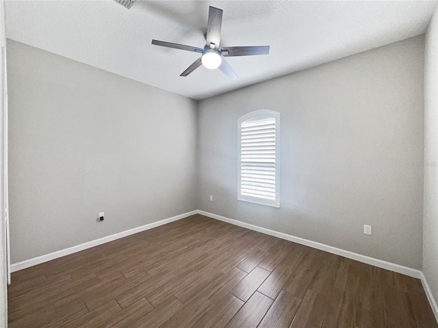 spare room with dark hardwood / wood-style floors and ceiling fan