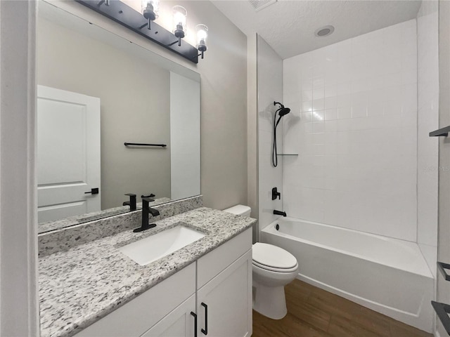 full bathroom with vanity, hardwood / wood-style flooring, shower / washtub combination, and toilet