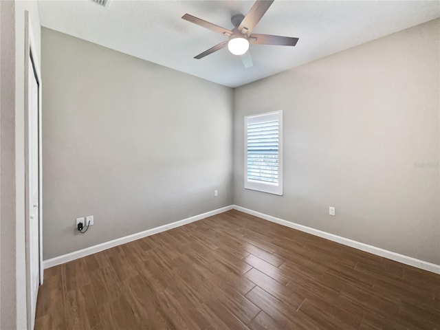 empty room featuring dark hardwood / wood-style floors and ceiling fan