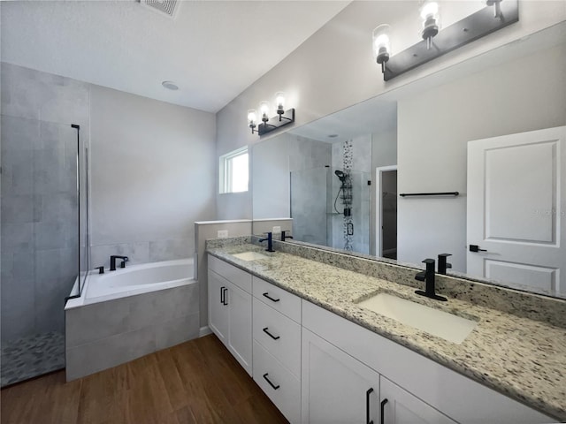 bathroom with vanity, separate shower and tub, and hardwood / wood-style floors