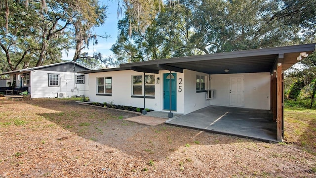 ranch-style house featuring a carport