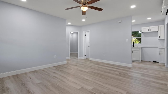 empty room with light hardwood / wood-style floors and ceiling fan