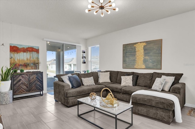 living room featuring a textured ceiling and a chandelier