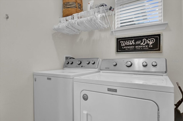 clothes washing area featuring separate washer and dryer