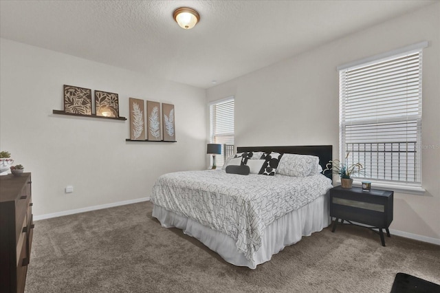 bedroom with carpet floors and a textured ceiling