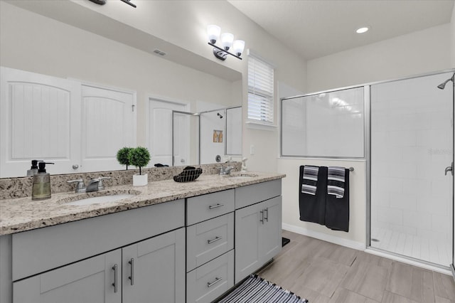 bathroom featuring vanity and a shower with shower door