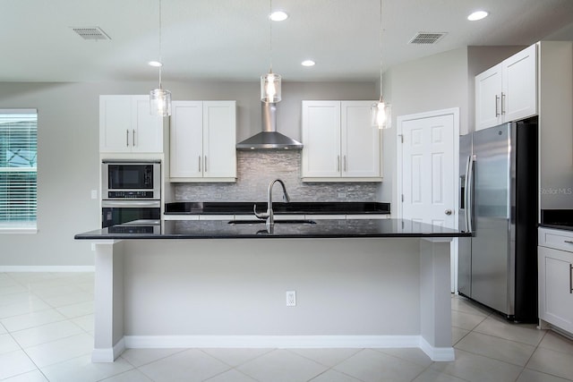 15165 Heron Hideaway Cir, Winter Garden, FL 34787 - kitchen featuring sink, stainless steel fridge, a kitchen island with sink, and white cabinets