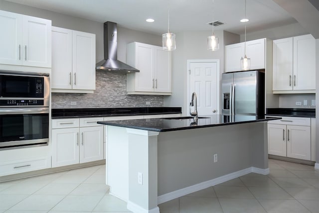 15165 Heron Hideaway Cir, Winter Garden, FL 34787 - kitchen featuring wall chimney range hood, sink, white cabinetry, stainless steel appliances, and an island with sink