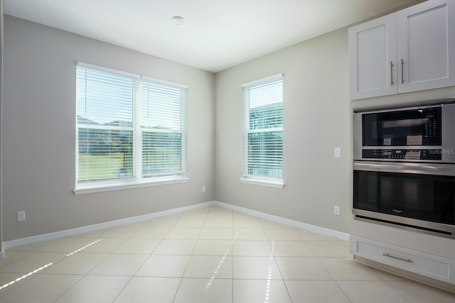 15165 Heron Hideaway Cir, Winter Garden, FL 34787 - kitchen with a healthy amount of sunlight, black microwave, oven, and white cabinets