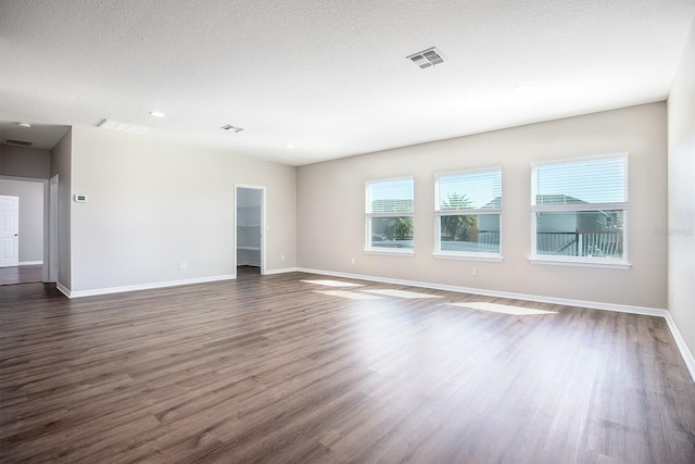 15165 Heron Hideaway Cir, Winter Garden, FL 34787 - unfurnished room featuring dark wood-type flooring and a textured ceiling