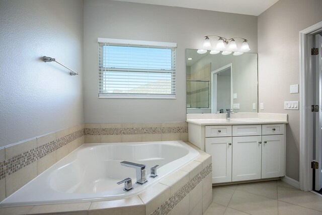 15165 Heron Hideaway Cir, Winter Garden, FL 34787 - bathroom featuring vanity, plus walk in shower, and tile patterned flooring