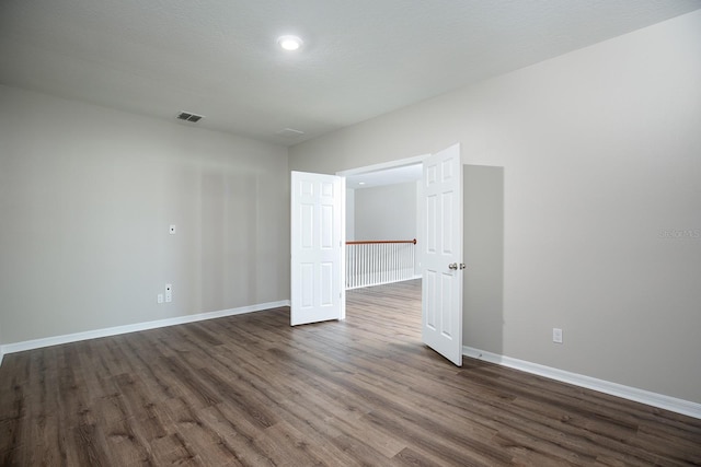 15165 Heron Hideaway Cir, Winter Garden, FL 34787 - unfurnished room with dark wood-type flooring and a textured ceiling