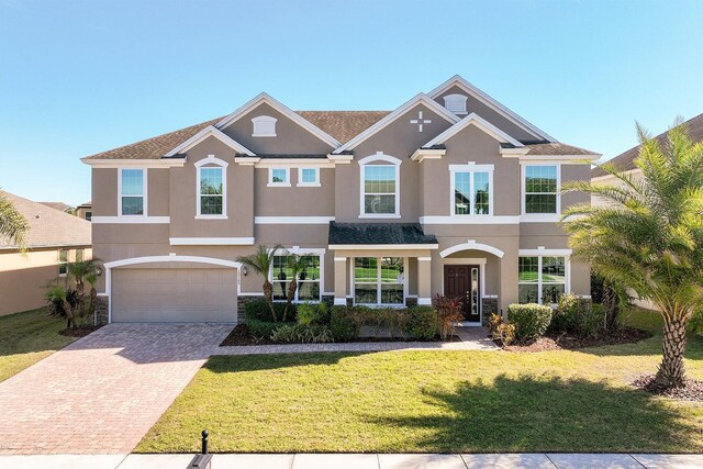 15165 Heron Hideaway Cir, Winter Garden, FL 34787 - view of front of home with a garage and a front lawn
