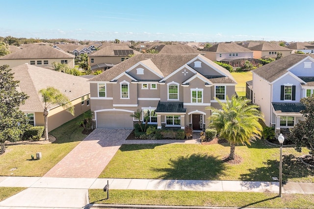 15165 Heron Hideaway Cir, Winter Garden, FL 34787 - view of front of home with a garage and a front lawn