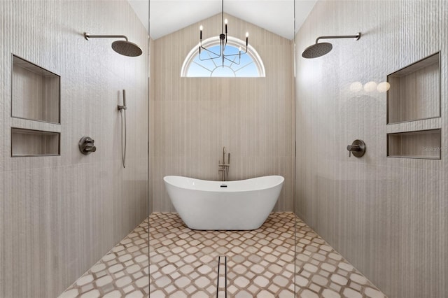 bathroom featuring an inviting chandelier, vaulted ceiling, independent shower and bath, and tile walls