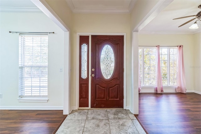 entryway with ornamental molding, light hardwood / wood-style floors, and ceiling fan