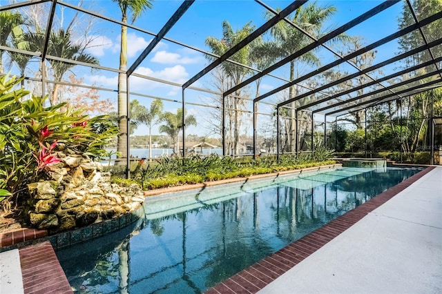 view of pool with a water view and glass enclosure