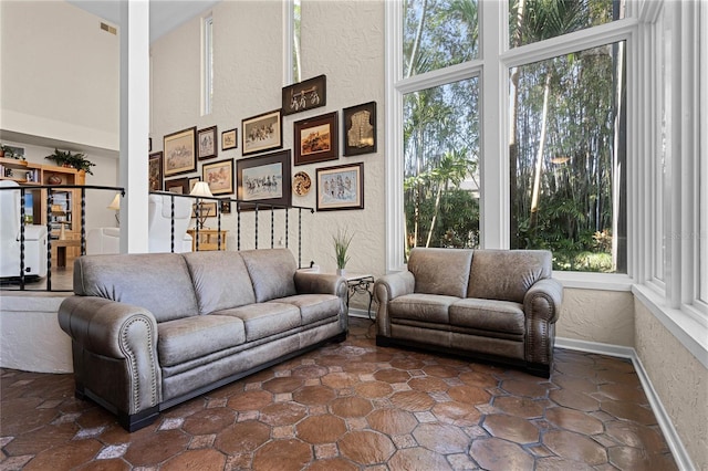 living room featuring a towering ceiling