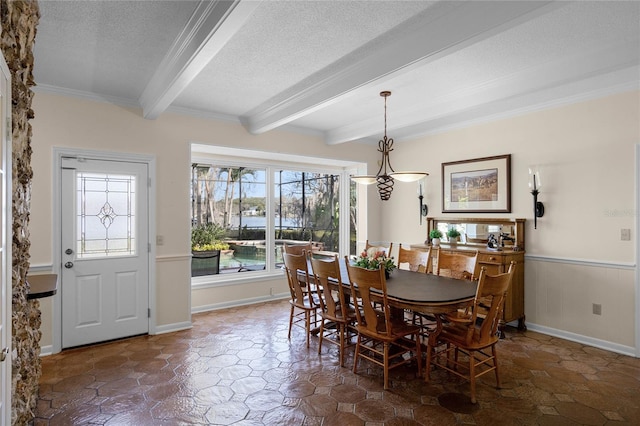 dining room with beamed ceiling, crown molding, and a textured ceiling