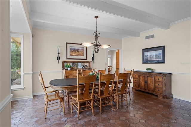 dining space featuring crown molding and beam ceiling