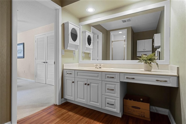 bathroom featuring vanity, hardwood / wood-style floors, and walk in shower