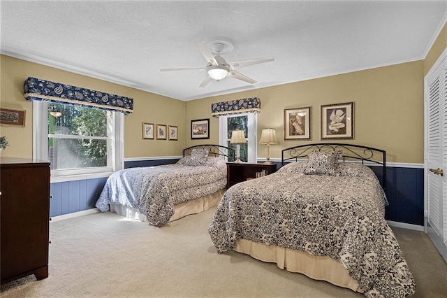 bedroom featuring a textured ceiling, ceiling fan, and carpet flooring