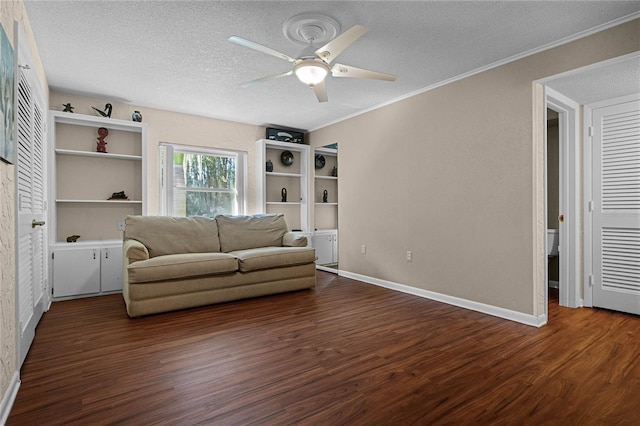 unfurnished living room featuring ceiling fan, dark hardwood / wood-style floors, crown molding, and a textured ceiling