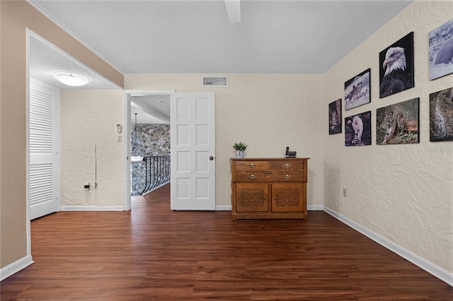 spare room with dark wood-type flooring