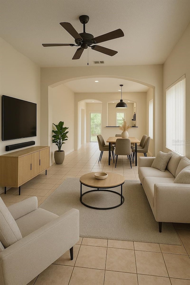 13900 Corrine Key Pl, Orlando, FL 32824 - living area featuring arched walkways, light tile patterned flooring, and a ceiling fan