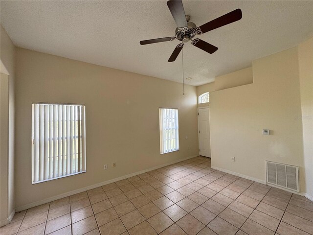 13900 Corrine Key Pl, Orlando, FL 32824 - empty room with a ceiling fan, light tile patterned flooring, a textured ceiling, and baseboards