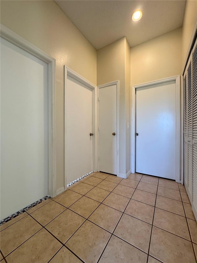 13900 Corrine Key Pl, Orlando, FL 32824 - hallway featuring light tile patterned flooring and recessed lighting