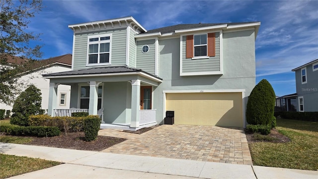 view of front of property featuring a garage and covered porch