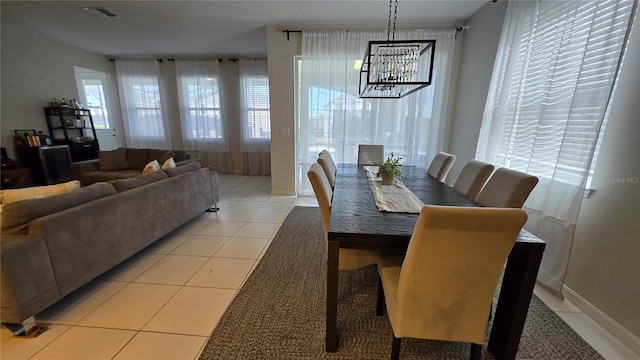 tiled dining area featuring a notable chandelier