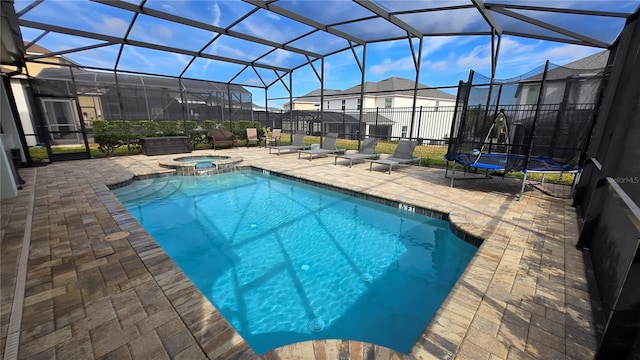 view of swimming pool featuring a lanai, a patio, and an in ground hot tub