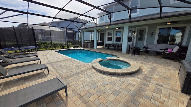 view of swimming pool featuring an outdoor living space, an in ground hot tub, a lanai, and a patio