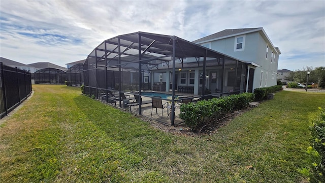 rear view of property with a yard, a lanai, and a patio area