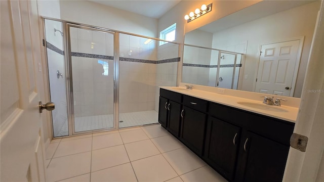 bathroom with tile patterned flooring, vanity, and a shower with door