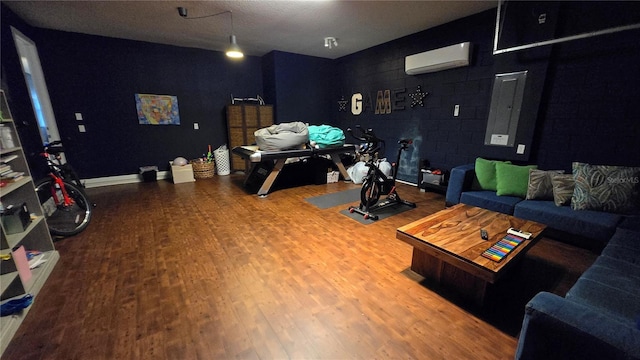 living room with wood-type flooring and a wall unit AC