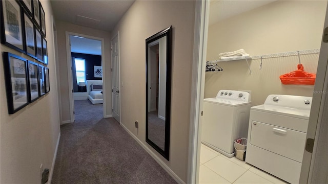 laundry area featuring light colored carpet and washer and dryer