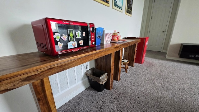 bar with wooden counters and carpet floors