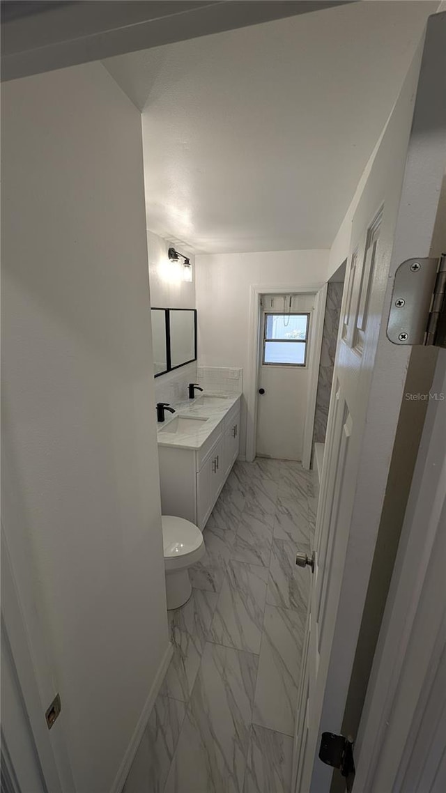 bathroom featuring vanity, toilet, and a shower