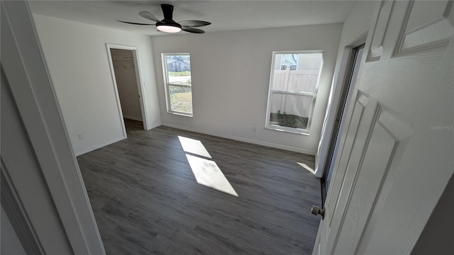 spare room with dark wood-type flooring and ceiling fan