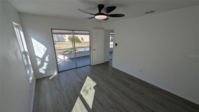 spare room with dark hardwood / wood-style floors and ceiling fan