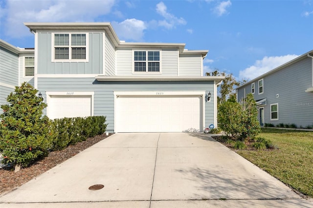 view of front property featuring a garage and a front lawn