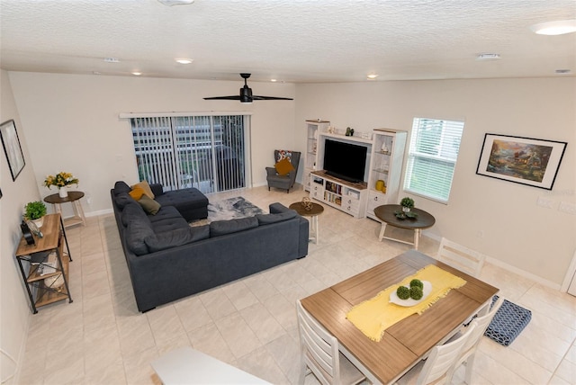 2623 Buena View Rd, Kissimmee, FL 34746 - living room featuring light tile patterned floors, ceiling fan, a textured ceiling, recessed lighting, and baseboards