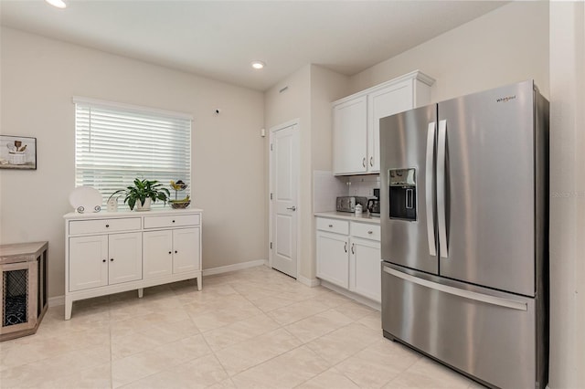 2623 Buena View Rd, Kissimmee, FL 34746 - kitchen featuring stainless steel refrigerator with ice dispenser, white cabinets, backsplash, light countertops, and recessed lighting