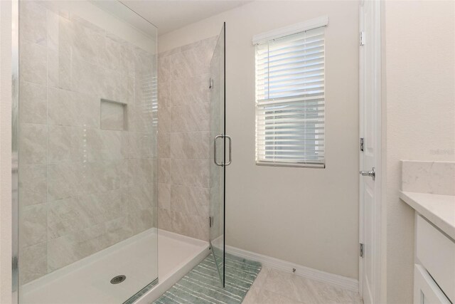 2623 Buena View Rd, Kissimmee, FL 34746 - bathroom with a stall shower, vanity, tile patterned flooring, and baseboards
