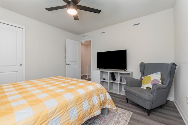 2623 Buena View Rd, Kissimmee, FL 34746 - bedroom featuring wood finished floors, a ceiling fan, and baseboards