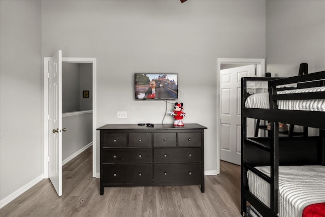 bedroom featuring light wood-style flooring and baseboards